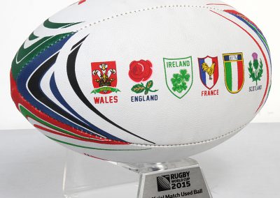 Match used rugby ball on stand