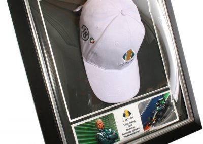 Framed Lotus Racing team cap in dome
